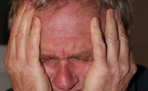 man holding head